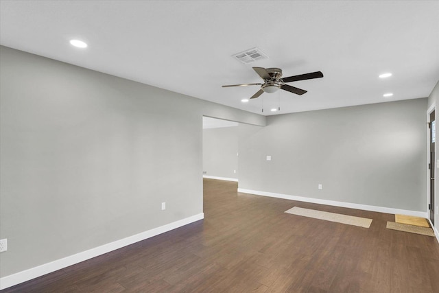 spare room with dark hardwood / wood-style floors and ceiling fan