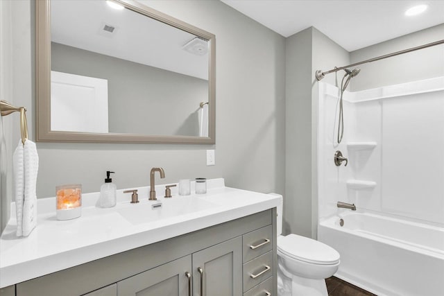 full bathroom with vanity, hardwood / wood-style floors, shower / bathing tub combination, and toilet