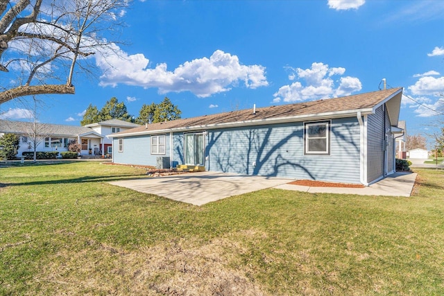 rear view of house with a lawn and a patio area