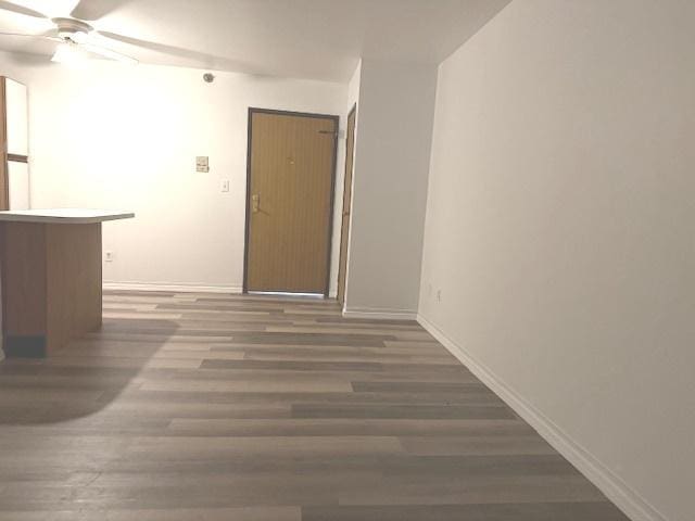 unfurnished room with dark hardwood / wood-style floors and ceiling fan