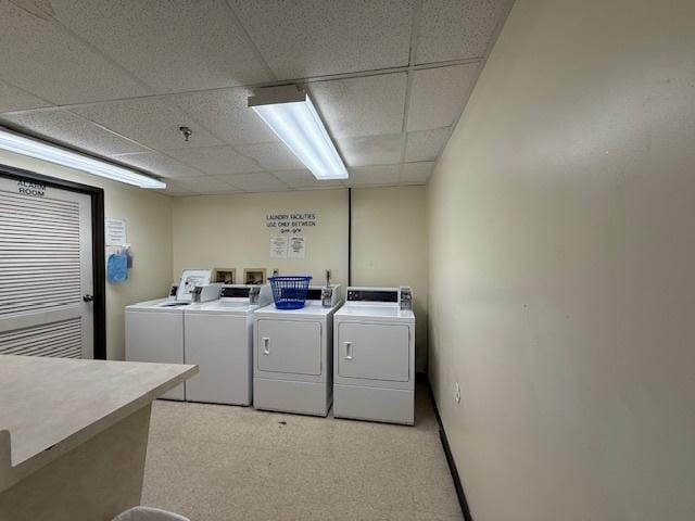 laundry room featuring light carpet and washer and clothes dryer