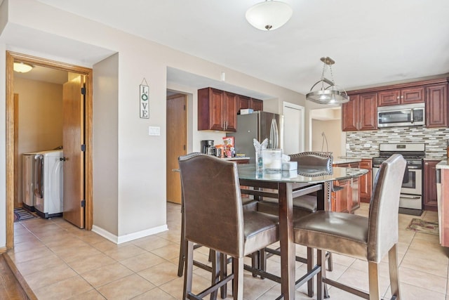 tiled dining room with washer / clothes dryer