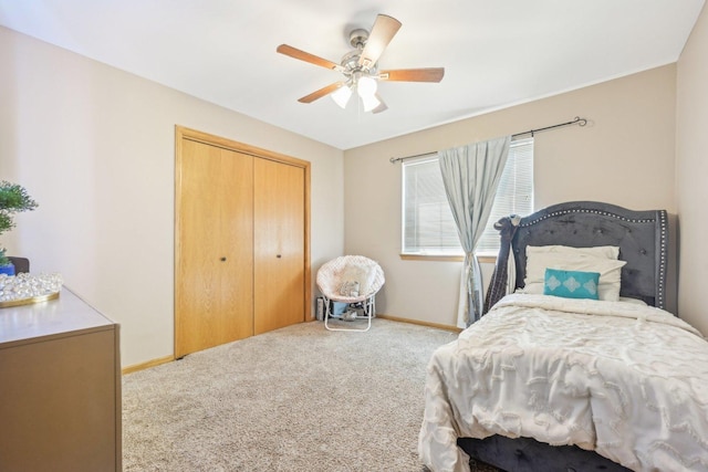 bedroom with ceiling fan, light carpet, and a closet