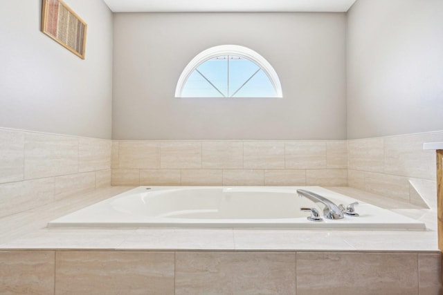 bathroom featuring tiled bath