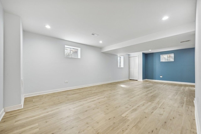 basement with light hardwood / wood-style floors