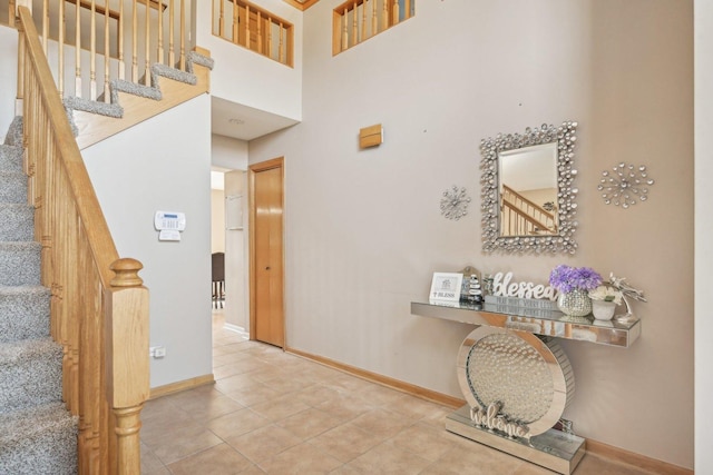 interior space featuring a high ceiling and tile patterned floors