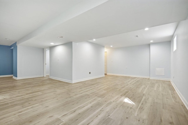 basement with light hardwood / wood-style floors