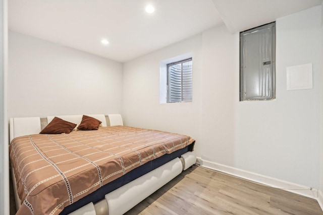 bedroom with wood-type flooring and electric panel