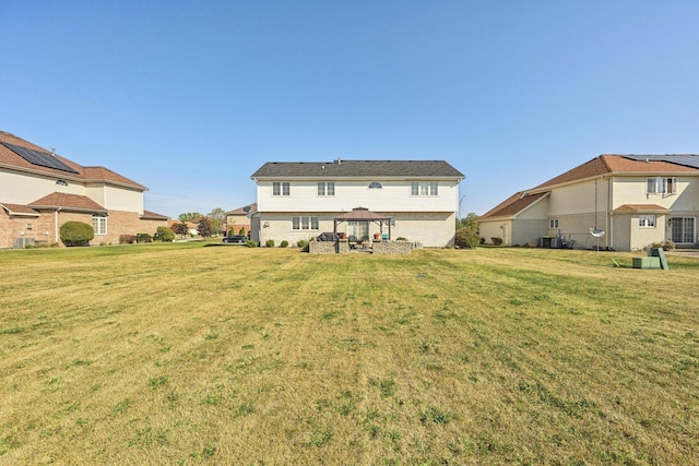 back of property featuring a gazebo and a lawn