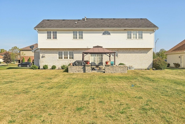 back of house with a gazebo and a lawn