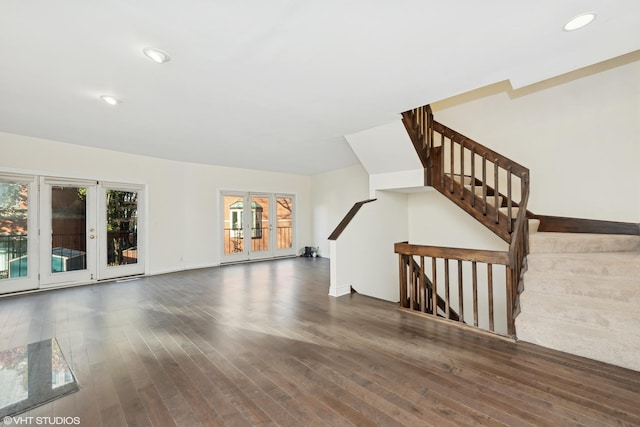 unfurnished living room featuring french doors and dark hardwood / wood-style flooring