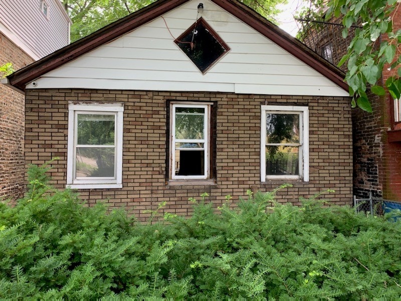 view of side of home with brick siding