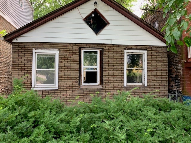 view of side of home with brick siding