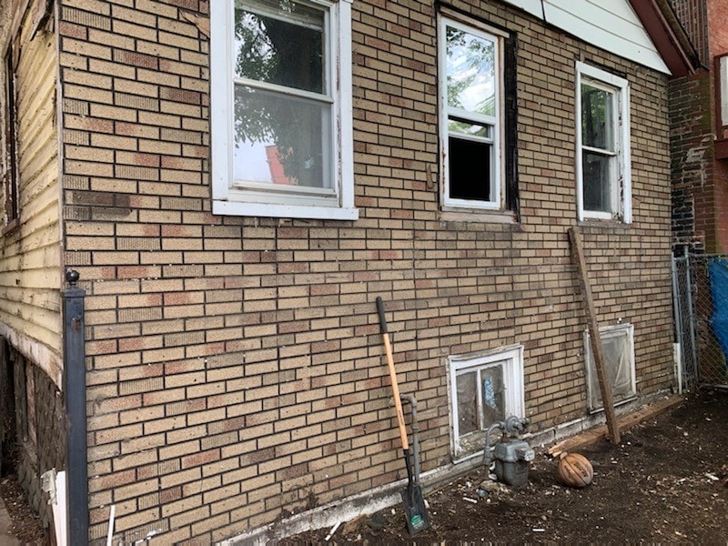 view of side of home featuring brick siding