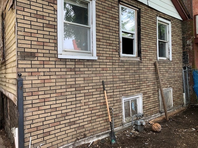 view of side of home featuring brick siding