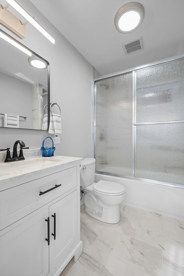 full bathroom with vanity, toilet, and bath / shower combo with glass door