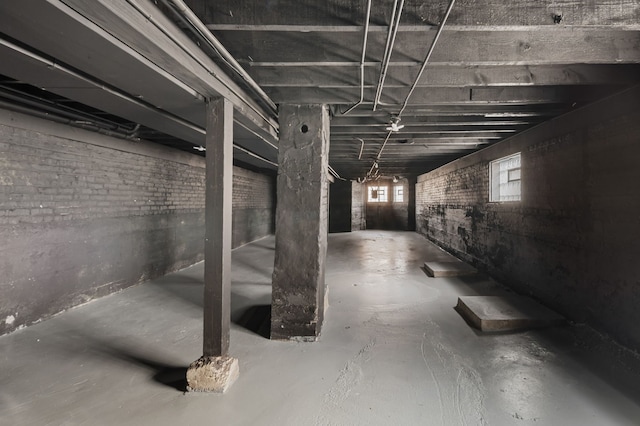 basement featuring brick wall