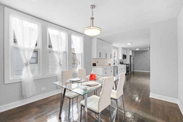 dining space featuring dark hardwood / wood-style flooring and sink