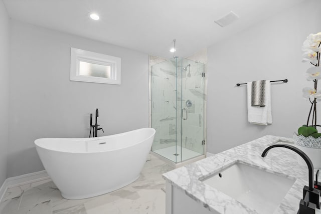 bathroom featuring vanity and independent shower and bath