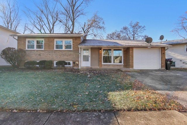 split level home with a garage and a front lawn