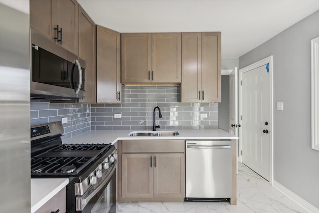 kitchen featuring decorative backsplash, stainless steel appliances, and sink