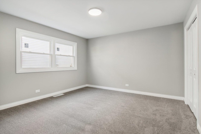 unfurnished bedroom with carpet floors and a closet