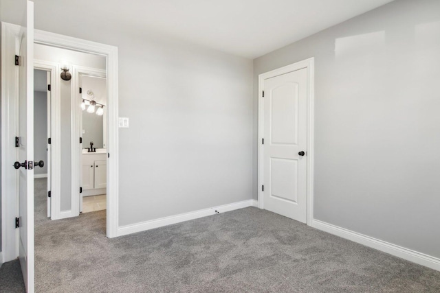 unfurnished bedroom featuring light carpet