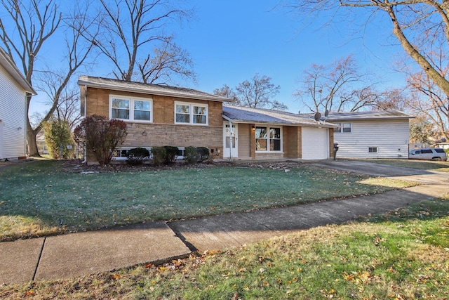 split level home with a front yard and a garage