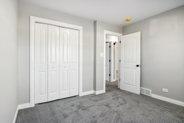 unfurnished bedroom featuring carpet floors and a closet