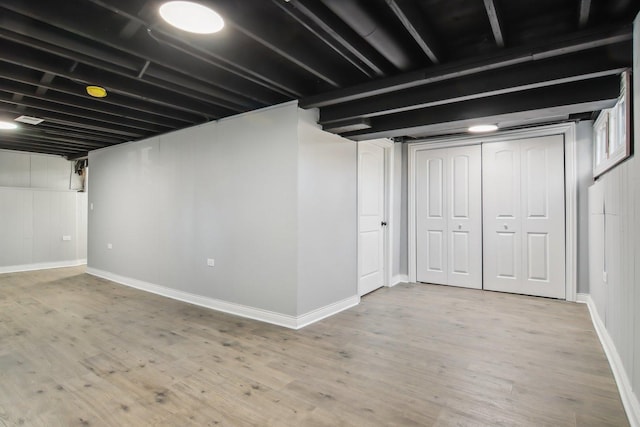 basement with hardwood / wood-style floors