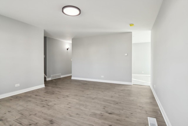 unfurnished room featuring hardwood / wood-style flooring