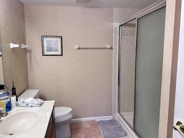 bathroom with vanity, toilet, and walk in shower