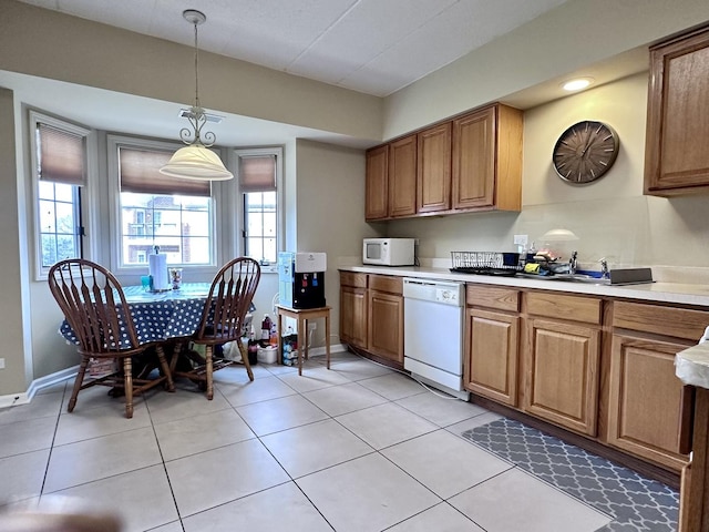 kitchen featuring pendant lighting, white appliances, and light tile patterned floors