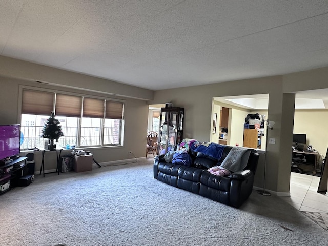 living room featuring light colored carpet and a textured ceiling