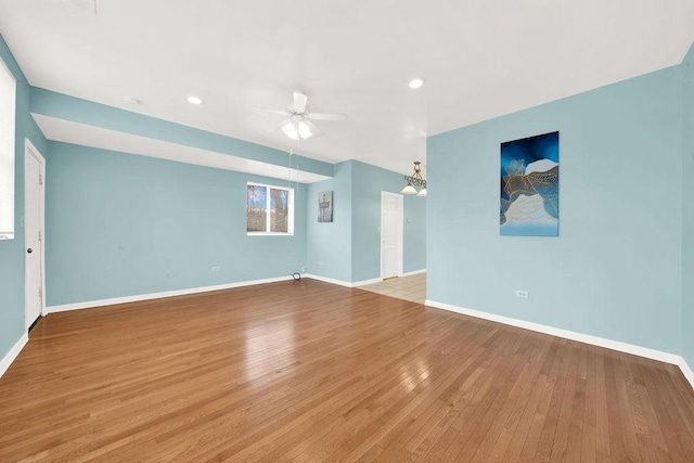 unfurnished living room featuring ceiling fan and light hardwood / wood-style flooring