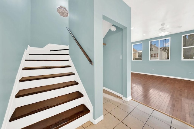 staircase featuring hardwood / wood-style floors and ceiling fan