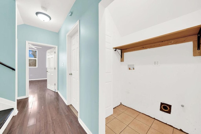 interior space featuring washer hookup, light hardwood / wood-style floors, ceiling fan, and electric dryer hookup