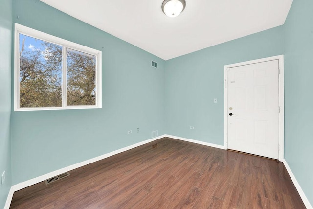 empty room featuring dark wood-type flooring