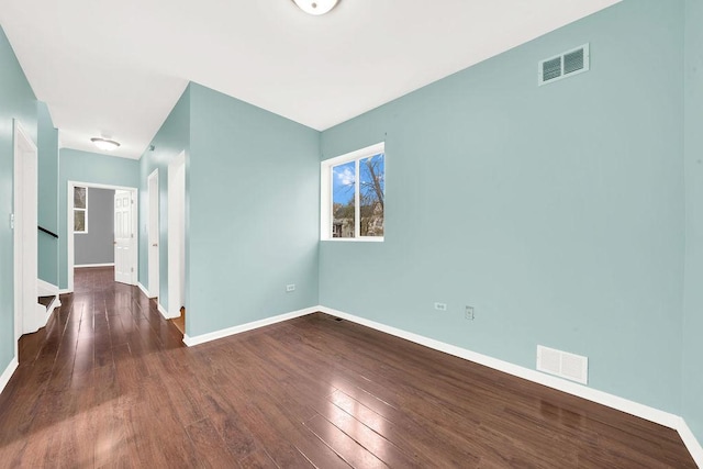 empty room with dark hardwood / wood-style floors