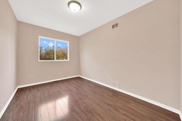 unfurnished room featuring dark hardwood / wood-style flooring