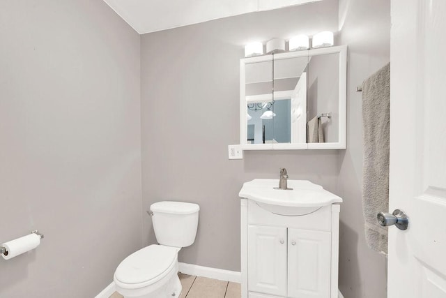 bathroom featuring tile patterned flooring, vanity, and toilet