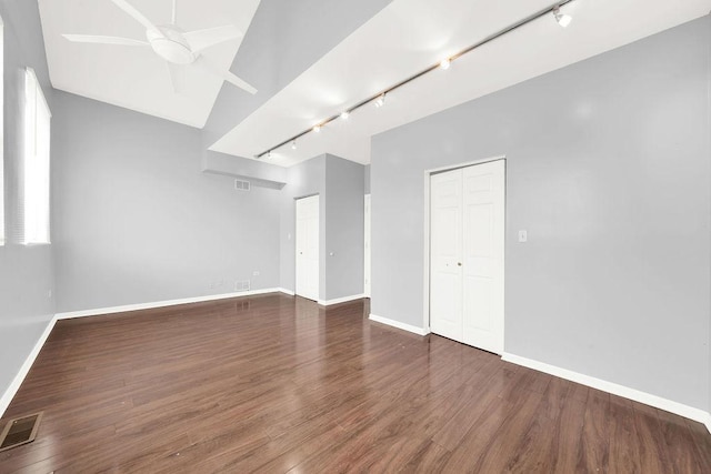 spare room featuring ceiling fan, dark hardwood / wood-style flooring, and track lighting