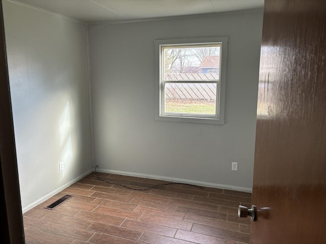 unfurnished room featuring hardwood / wood-style flooring