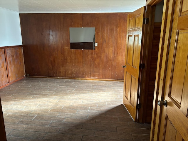 hallway featuring wooden walls