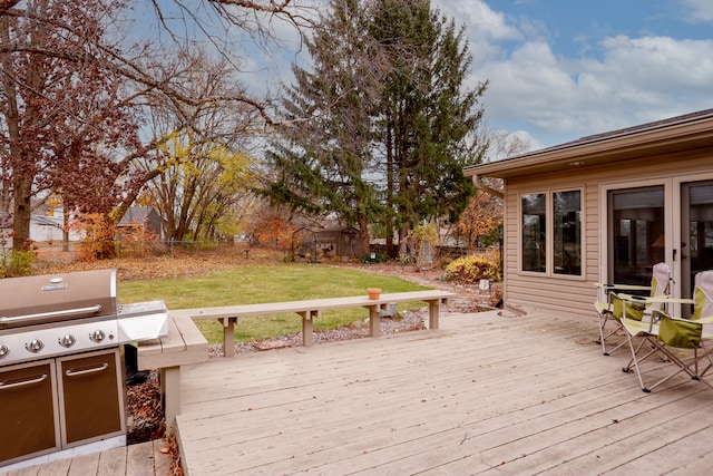 wooden deck featuring a yard