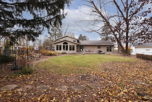 back of house with a lawn