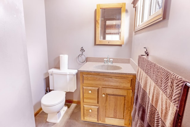 bathroom featuring tile patterned flooring, vanity, and toilet