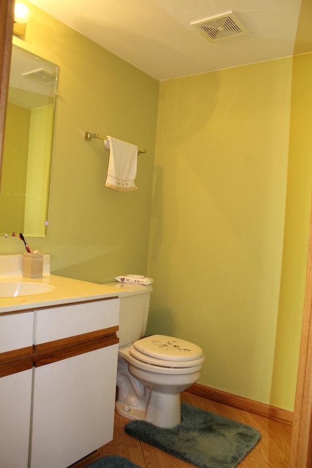 bathroom featuring hardwood / wood-style floors, vanity, and toilet