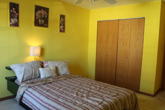 carpeted bedroom featuring ceiling fan and a closet