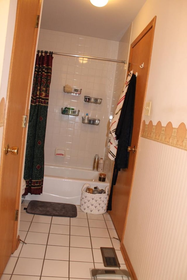 bathroom with tile patterned flooring and shower / bathtub combination with curtain